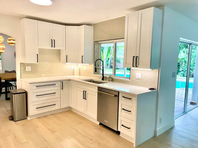 a kitchen with a sink stove and cabinets