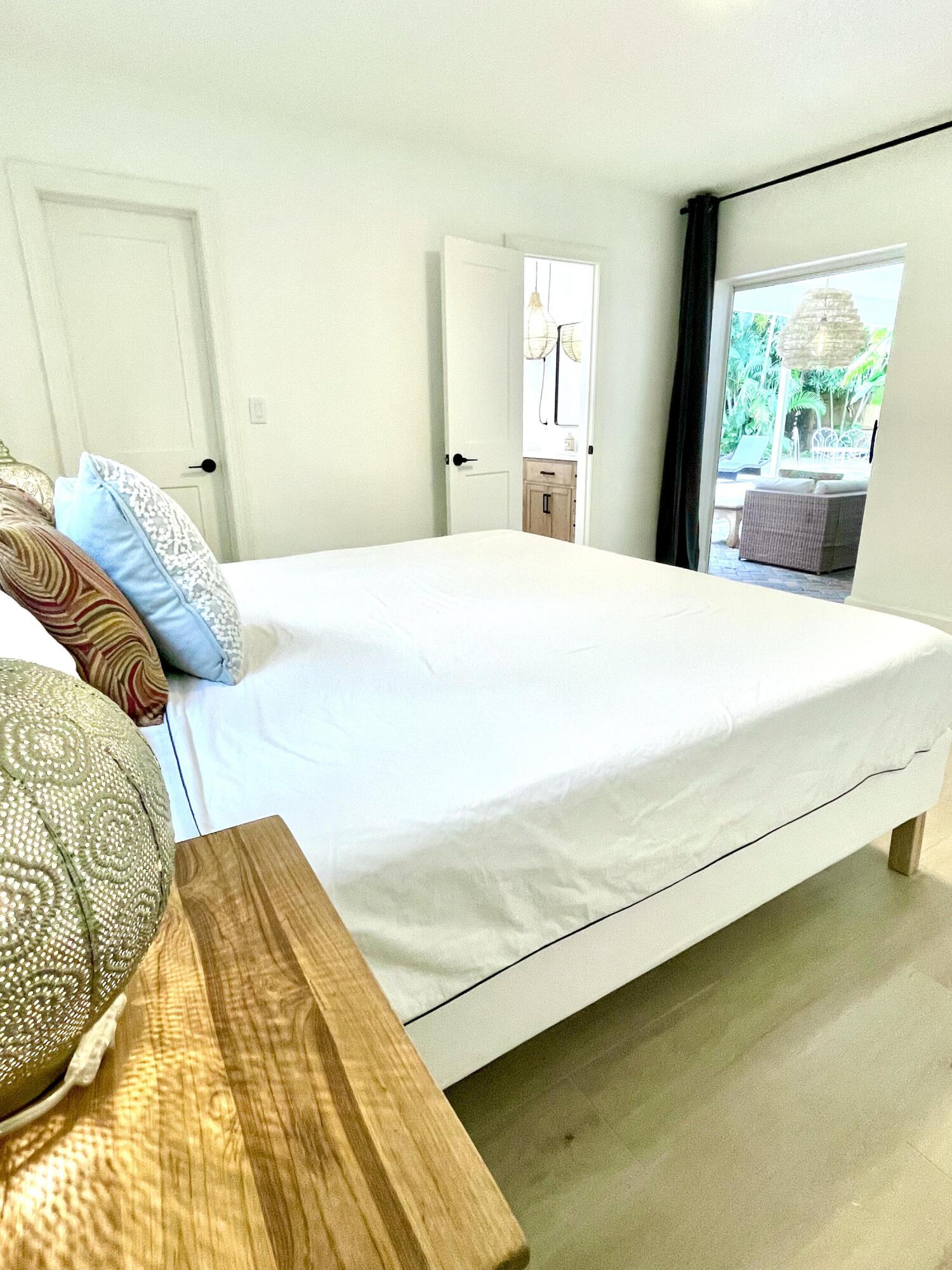 921 Northwest 7th Street Boca Raton, FL 33486 - Photo 7 of 18 a bedroom with a bed and a window