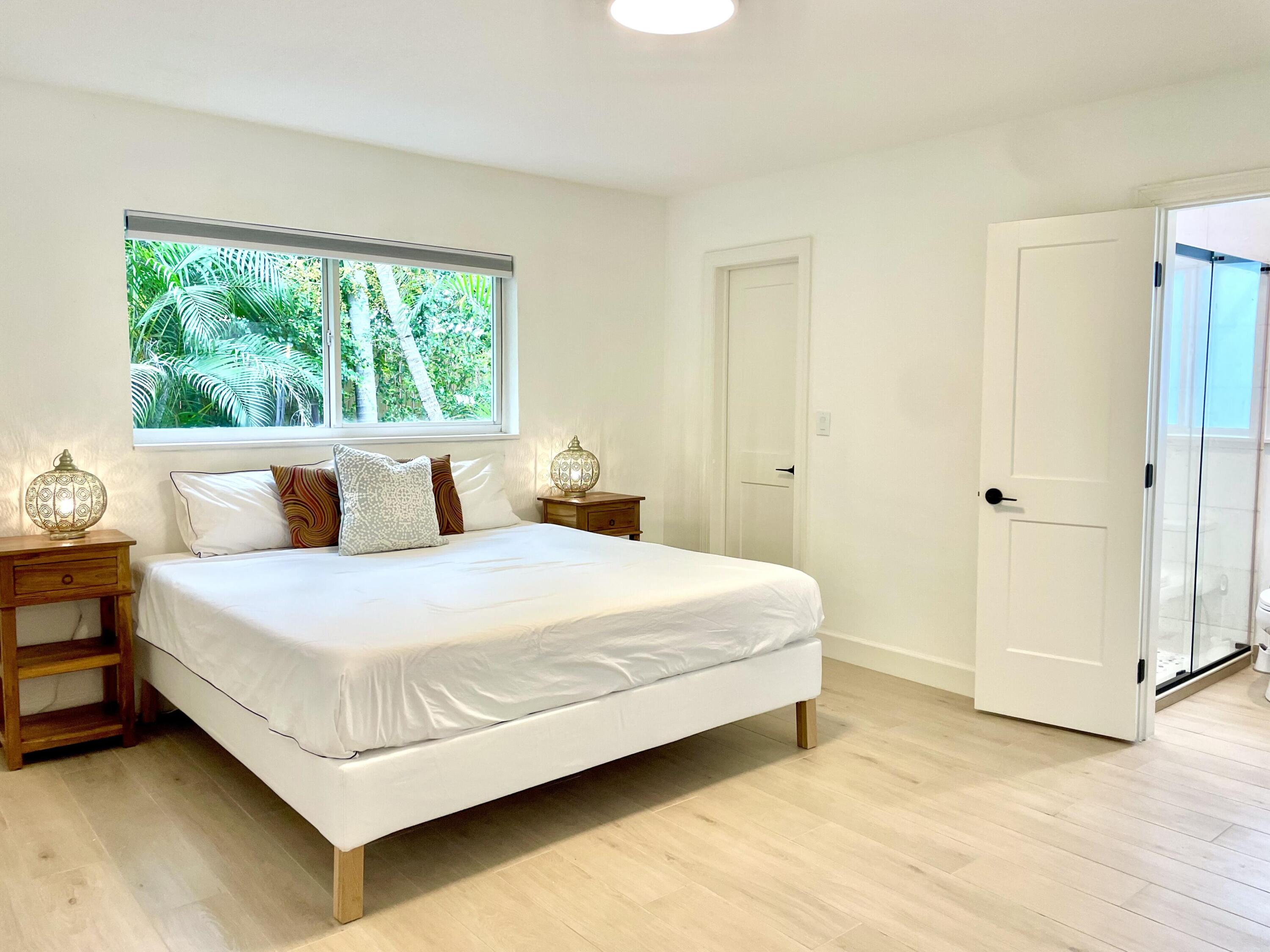 921 Northwest 7th Street Boca Raton, FL 33486 - Photo 8 of 18 a bedroom with a bed and window