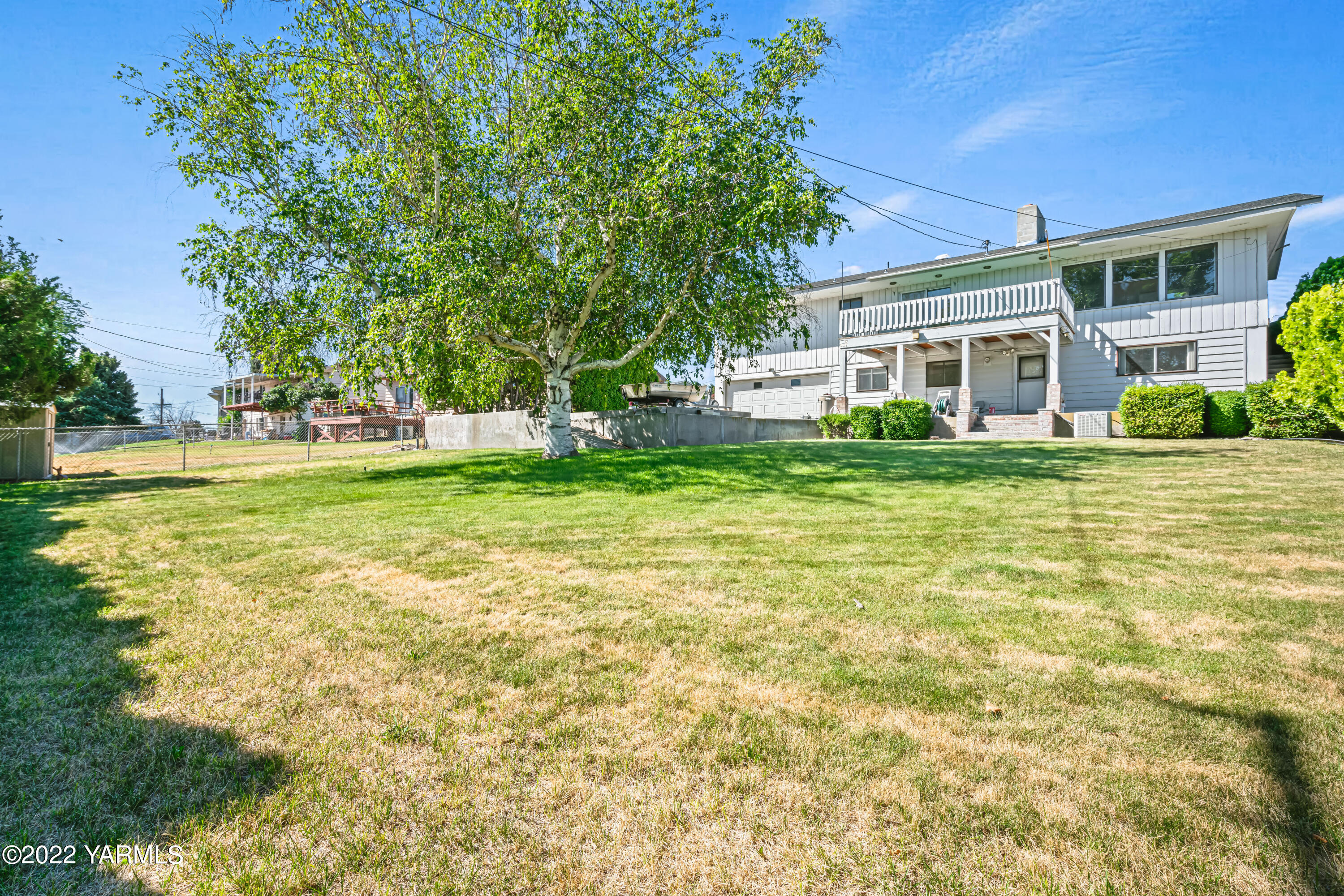511 Viewcrest Place Selah, WA 98942 - Photo 2 of 22 a view of a house with a big yard and large trees