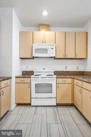 a kitchen with a white cabinets and white appliances
