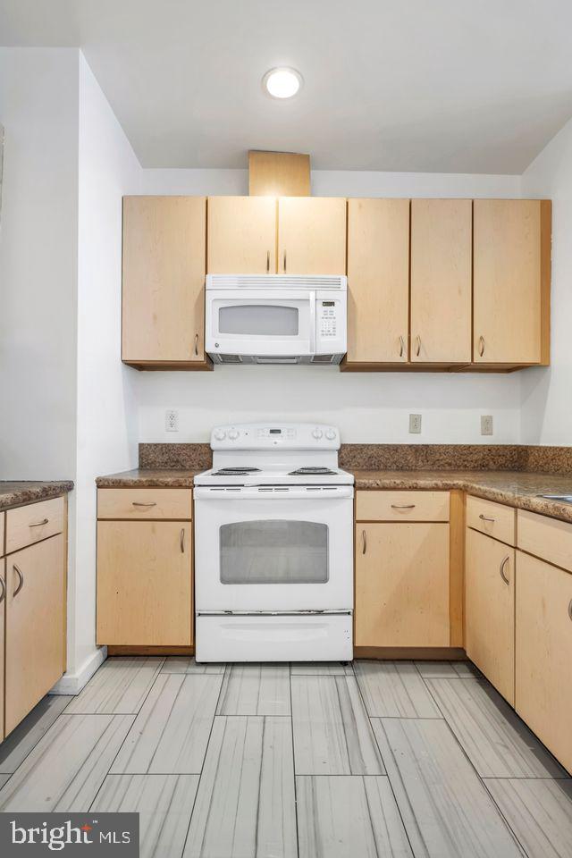 111 North 9th Street, Unit 707 Philadelphia, PA 19107 - Photo 2 of 20 a kitchen with a white cabinets and white appliances