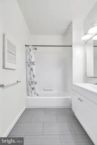 a bathroom with a bathtub and a shower