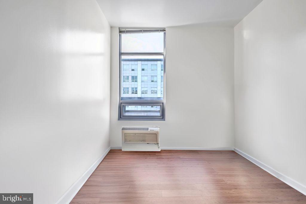 111 North 9th Street, Unit 707 Philadelphia, PA 19107 - Photo 8 of 20 wooden floor in an empty room with a window