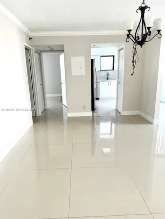 a view of a hallway with wooden floor windows