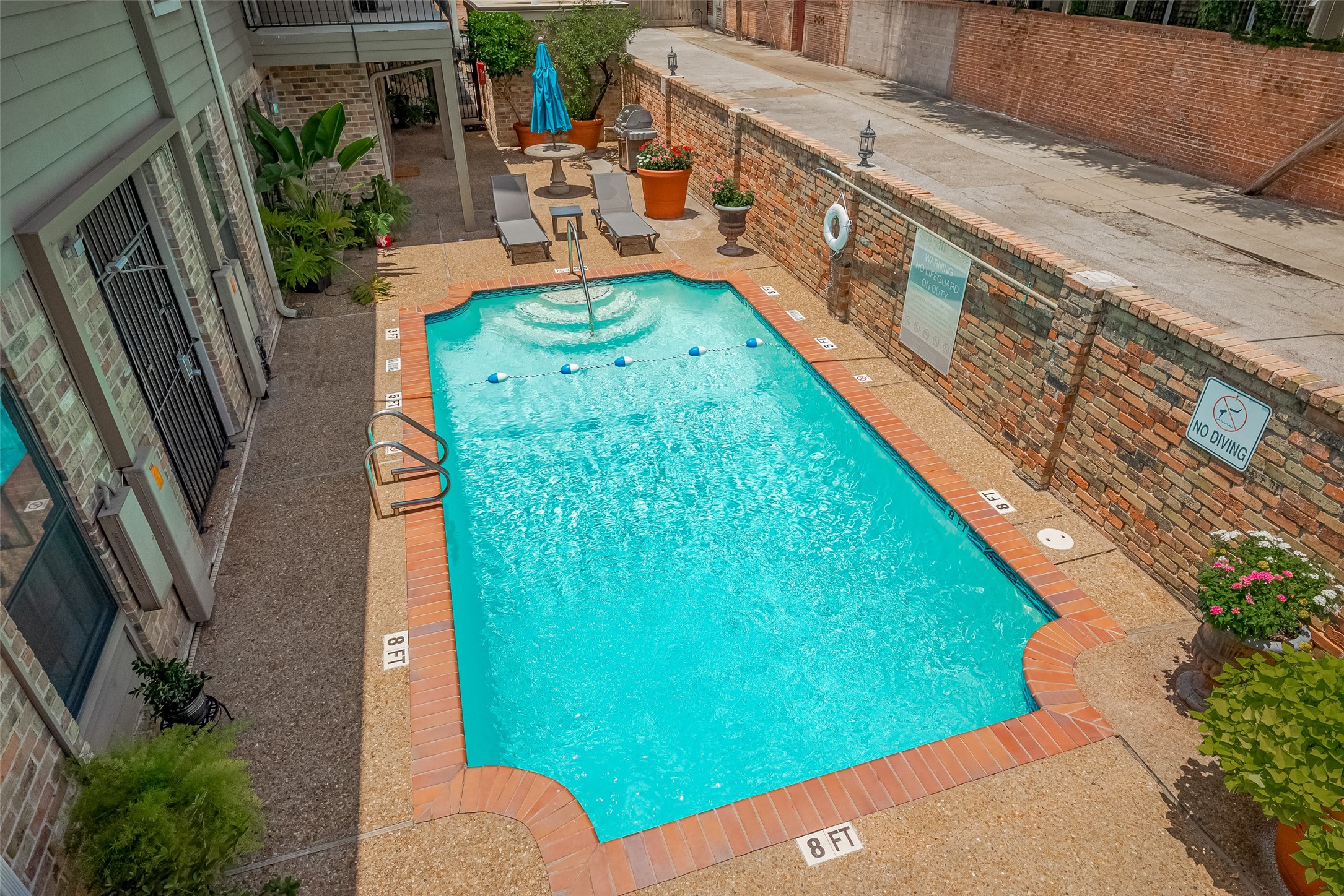 606 Marshall Street, Unit 35 Houston, TX 77006 - Photo 11 of 13 a backyard of a house with outdoor seating