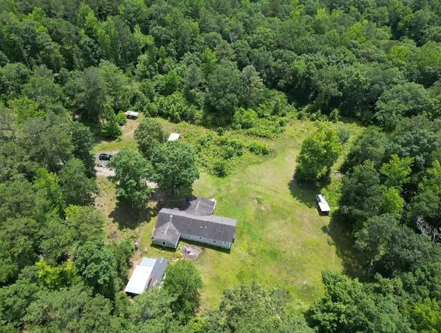 an aerial view of a house with a yard