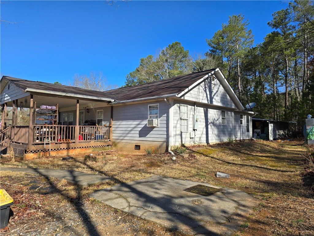 569 Appalachee Ridge Road Auburn, GA 30011 - Photo 5 of 6 a front view of house with yard outdoor seating and barbeque oven