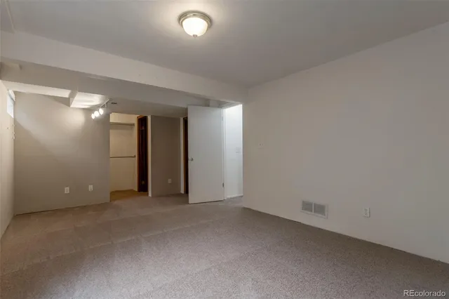 a view of walk in closet with empty racks