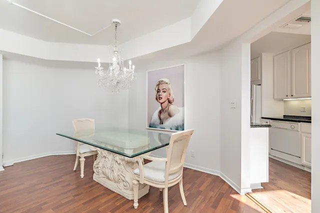 a view of a dining room with furniture wooden floor and chandelier