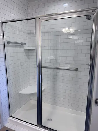 a bathroom with a glass shower door