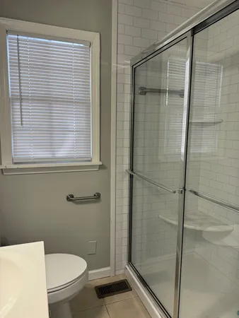 a bathroom with a toilet and a shower