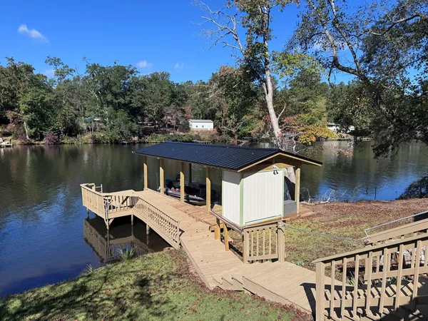 a view of a house with backyard and lake view