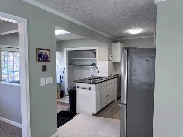 a kitchen with stainless steel appliances granite countertop a refrigerator and a stove