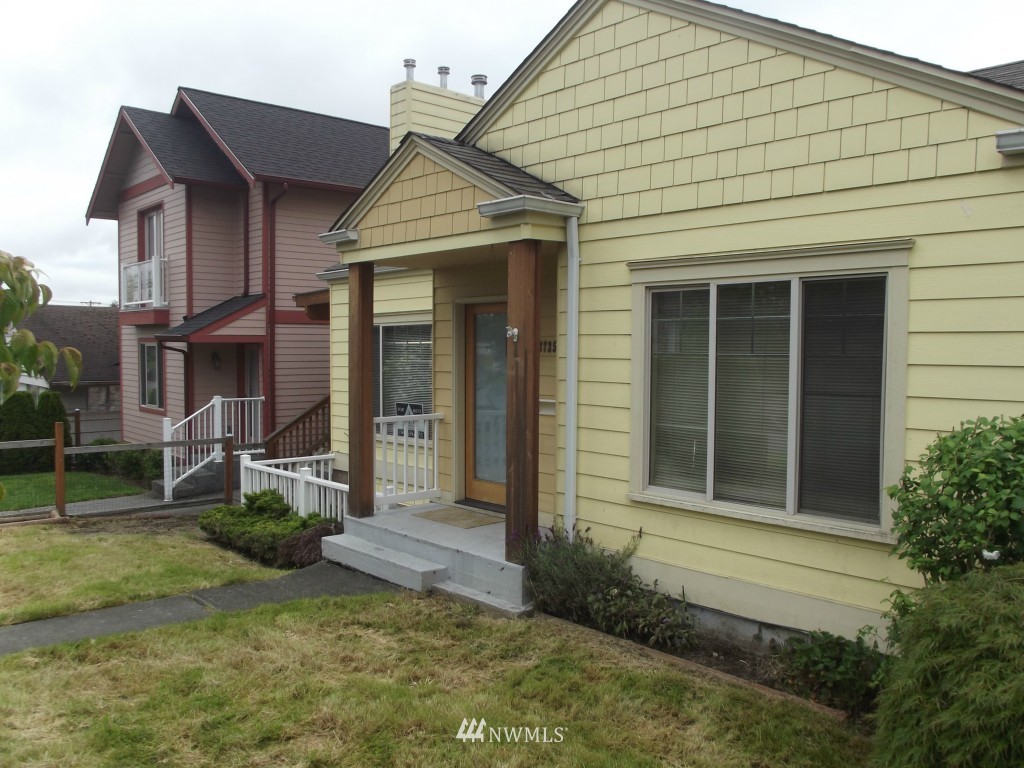 3725 Rockefeller Avenue Everett, WA 98201 - Photo 3 of 24 a view of a white house with large windows and a yard