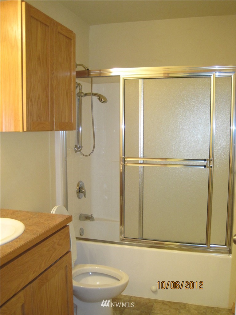 3725 Rockefeller Avenue Everett, WA 98201 - Photo 22 of 24 a bathroom with a granite countertop sink toilet and shower
