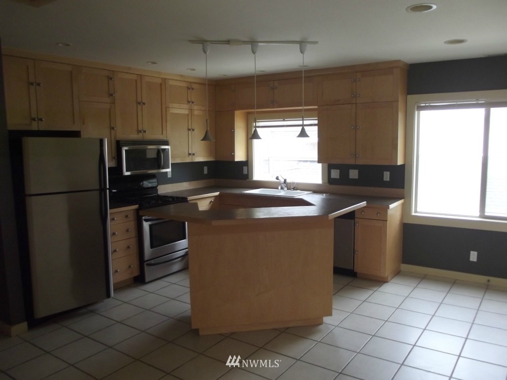 3725 Rockefeller Avenue Everett, WA 98201 - Photo 8 of 24 a kitchen with stainless steel appliances granite countertop a sink stove and refrigerator