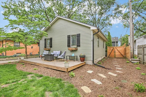 a view of a house with backyard and sitting area