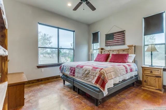 a bed sitting in a bedroom next to a window