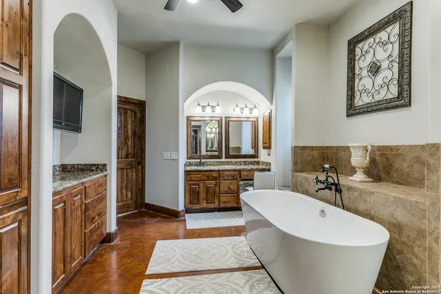 a spacious bathroom with a bathtub and a sink