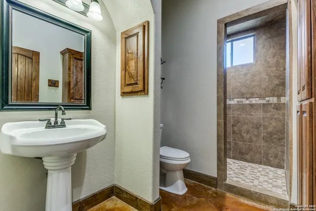 a bathroom with a sink toilet and shower