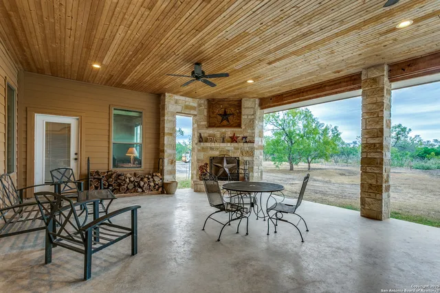 a view of a patio with table and chairs and potted plants