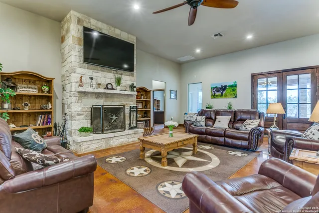a living room with furniture a flat screen tv and a fireplace