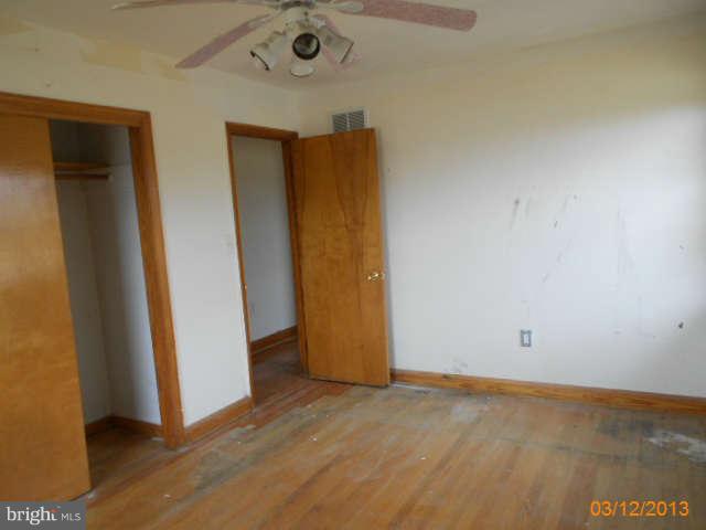 1555 Fairmount Road Hampstead, MD 21074 - Photo 15 of 23 an empty room with wooden floor and closet