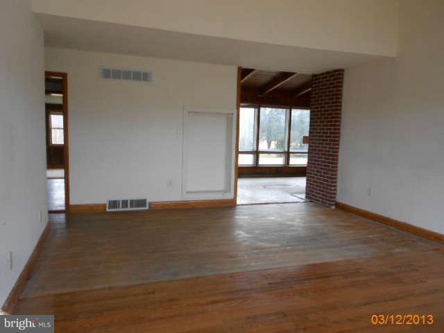 1555 Fairmount Road Hampstead, MD 21074 - Photo 5 of 23 an empty room with wooden floor and windows