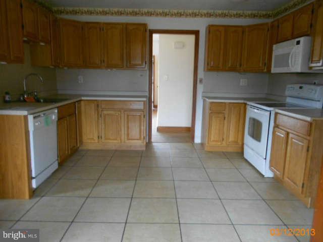 1555 Fairmount Road Hampstead, MD 21074 - Photo 10 of 23 a kitchen with a sink a stove and cabinets