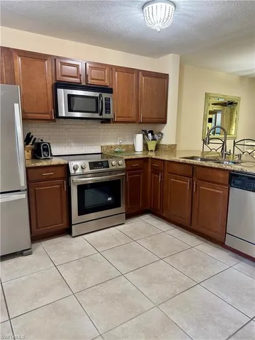 a bedroom with two beds and a chandelier