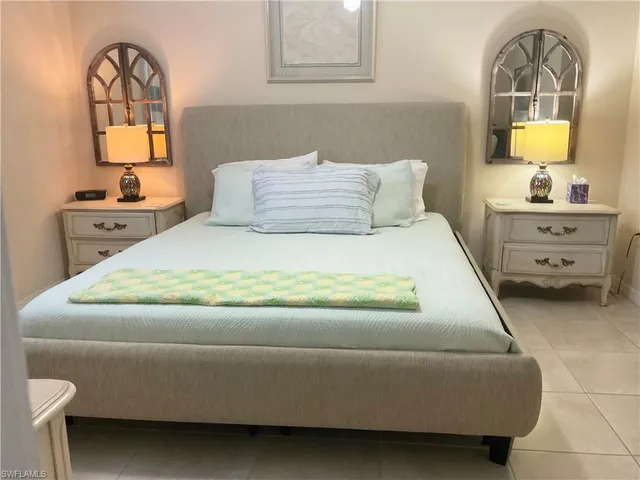 a bedroom with a bed and a television