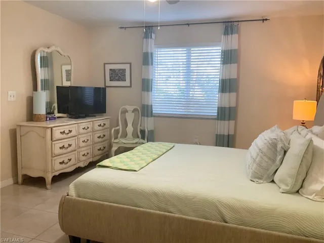 a white toilet sitting next to a white wall