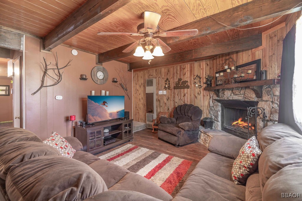 548 Riverside Avenue Sugarloaf, CA 92386 - Photo 9 of 37 a living room with furniture a fireplace and a ceiling fan