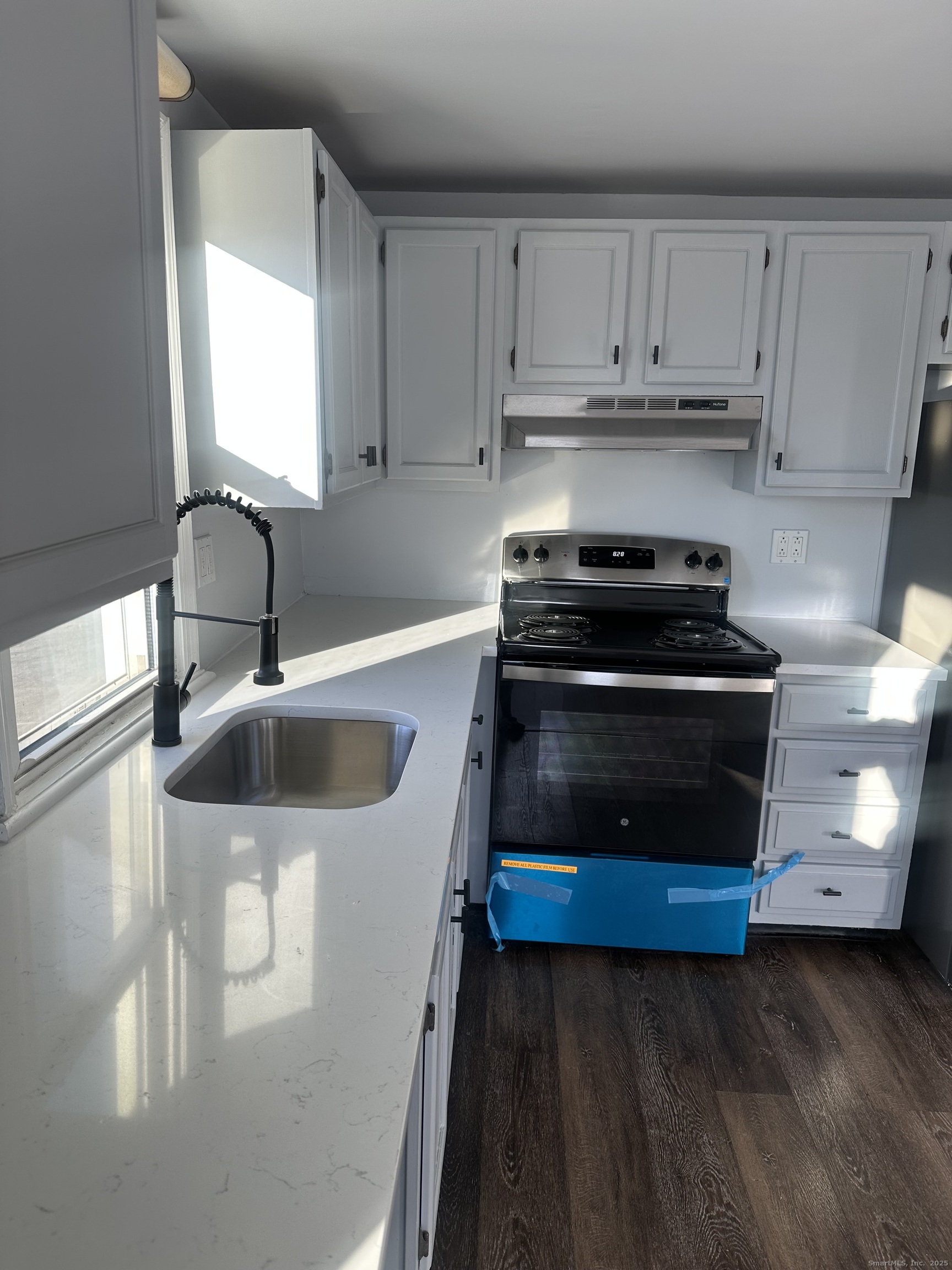 75 Broad Street, Unit 2 Norwalk, CT 06850 - Photo 3 of 10 a kitchen with stainless steel appliances a stove a sink and a microwave