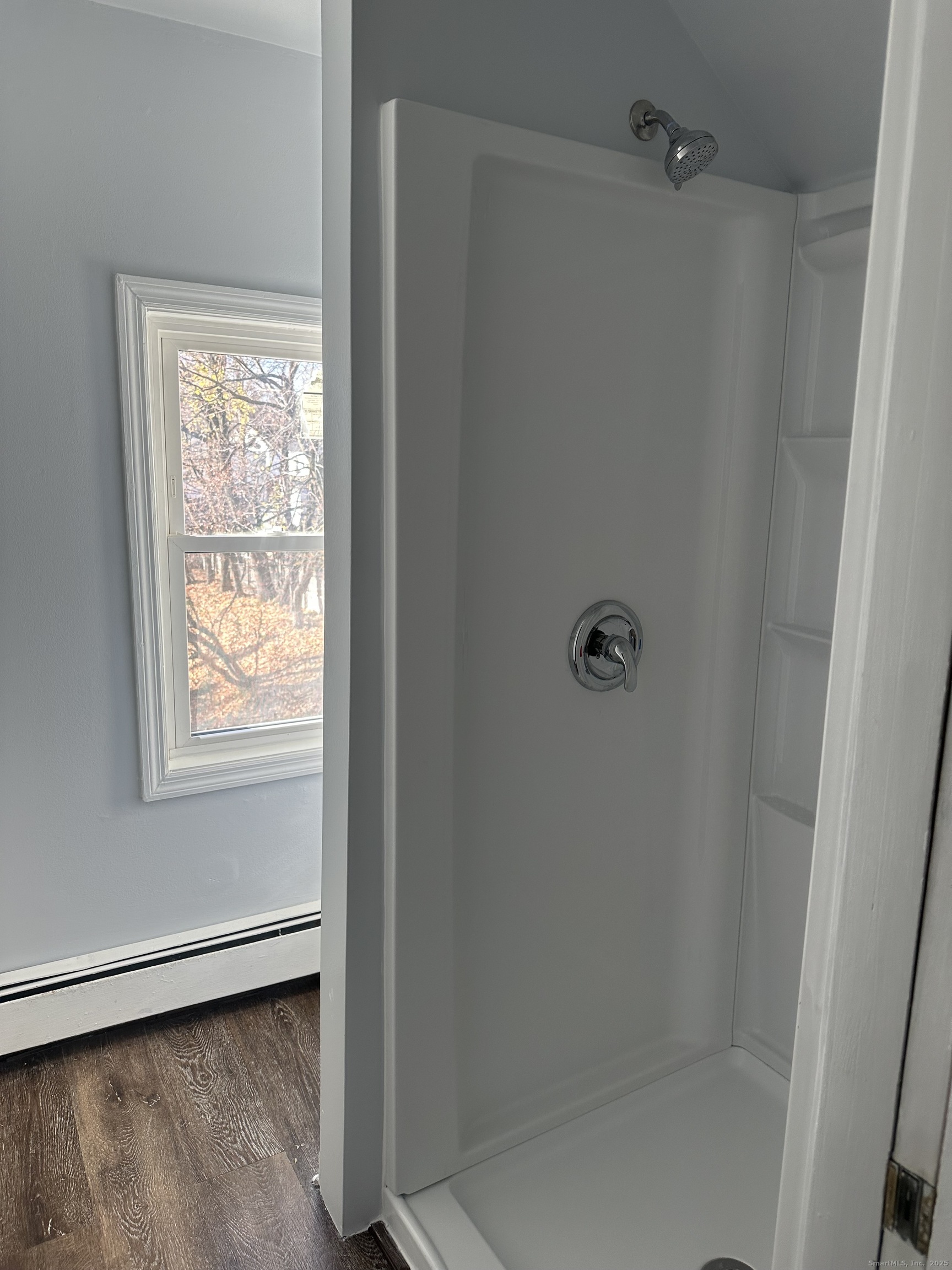 75 Broad Street, Unit 2 Norwalk, CT 06850 - Photo 4 of 10 a bathroom with a glass shower door