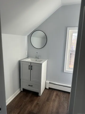 a room with wooden floor and windows