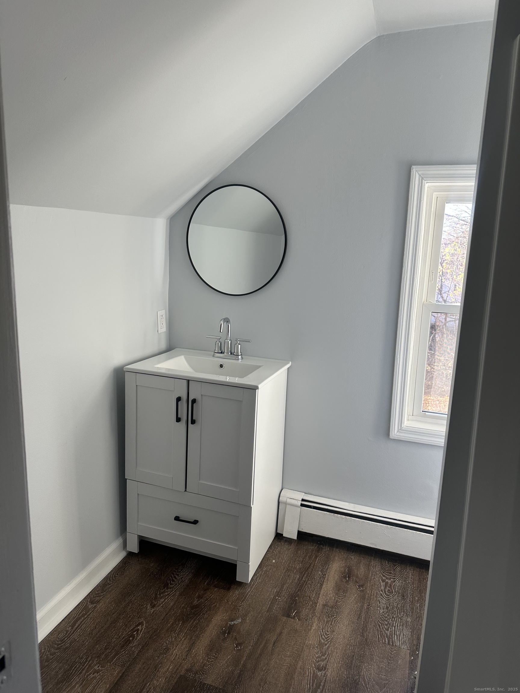 75 Broad Street, Unit 2 Norwalk, CT 06850 - Photo 5 of 10 a room with wooden floor and windows