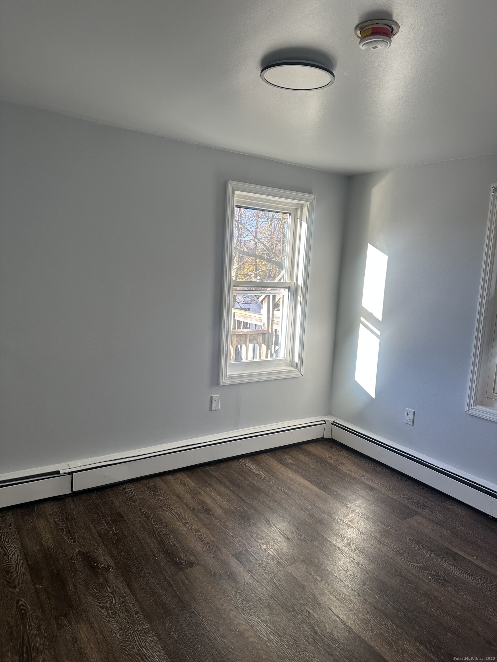 75 Broad Street, Unit 2 Norwalk, CT 06850 - Photo 10 of 10 an empty room with wooden floor and windows