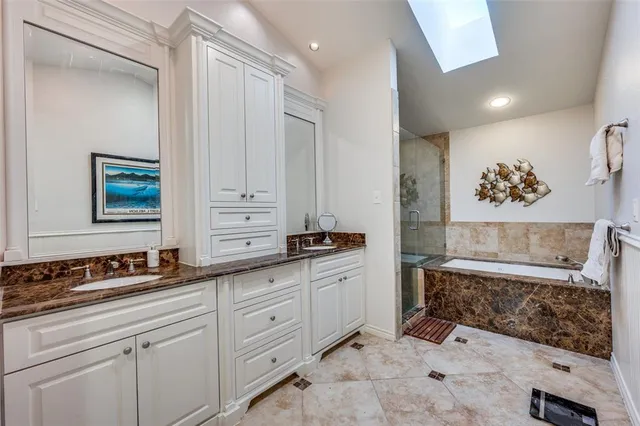 a spacious bathroom with a granite countertop sink a mirror and a