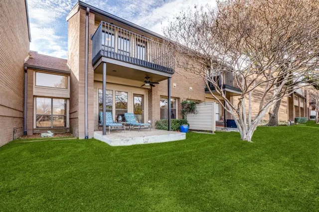 a view of a swimming pool with a patio and a yard