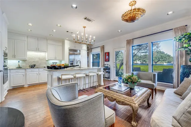 a living room with kitchen furniture and a large window