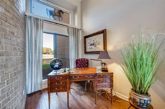 a view of a workspace with furniture and wooden floor