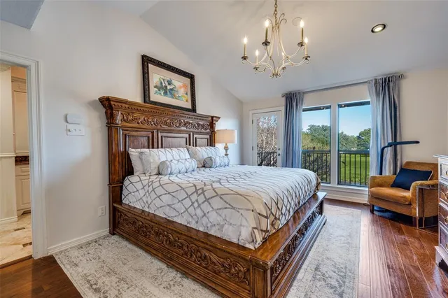 a bedroom with a bed a chandelier and a window
