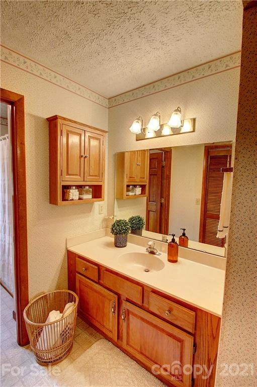 304 Oak Ridge Drive Clyde, NC 28721 - Photo 14 of 31 a bathroom with a double vanity sink and a mirror