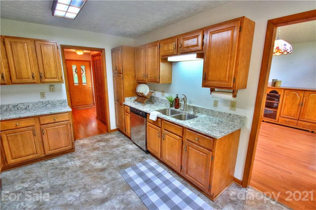 304 Oak Ridge Drive Clyde, NC 28721 - Photo 4 of 31 a kitchen with stainless steel appliances granite countertop a sink stove and refrigerator