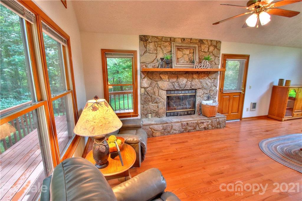 304 Oak Ridge Drive Clyde, NC 28721 - Photo 8 of 31 a living room with furniture and a fireplace