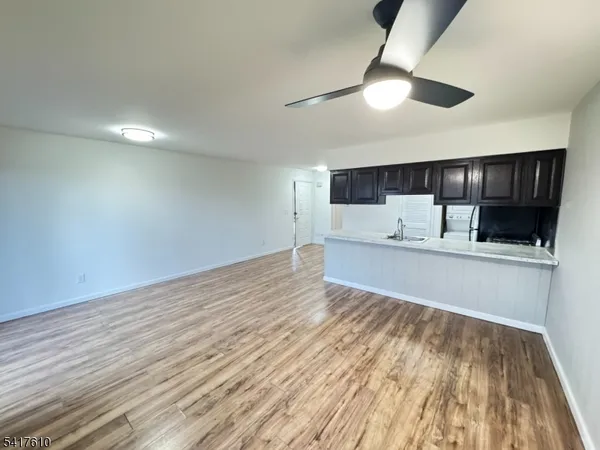 a view of kitchen with granite countertop cabinets and wooden floor