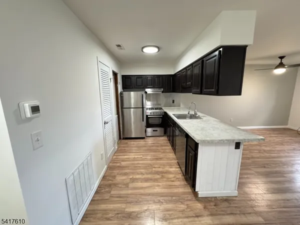 a kitchen with kitchen island cabinets and wooden floor