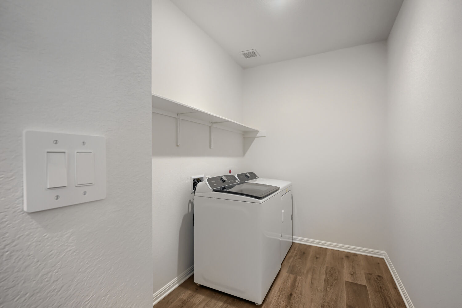 146 Diablo Rim Terrace Dripping Springs, TX 78620 - Photo 26 of 32 A well-organized laundry area offers a convenient washer and dryer set with practical shelving.